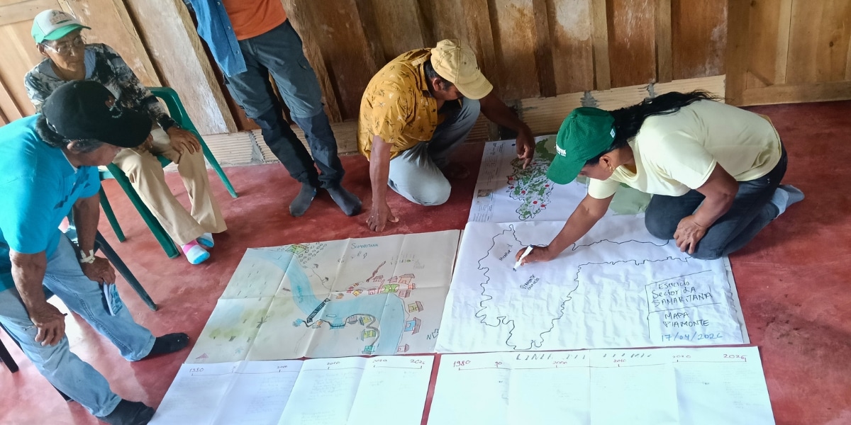 participantes reunidos en torno a unos mapas de la región