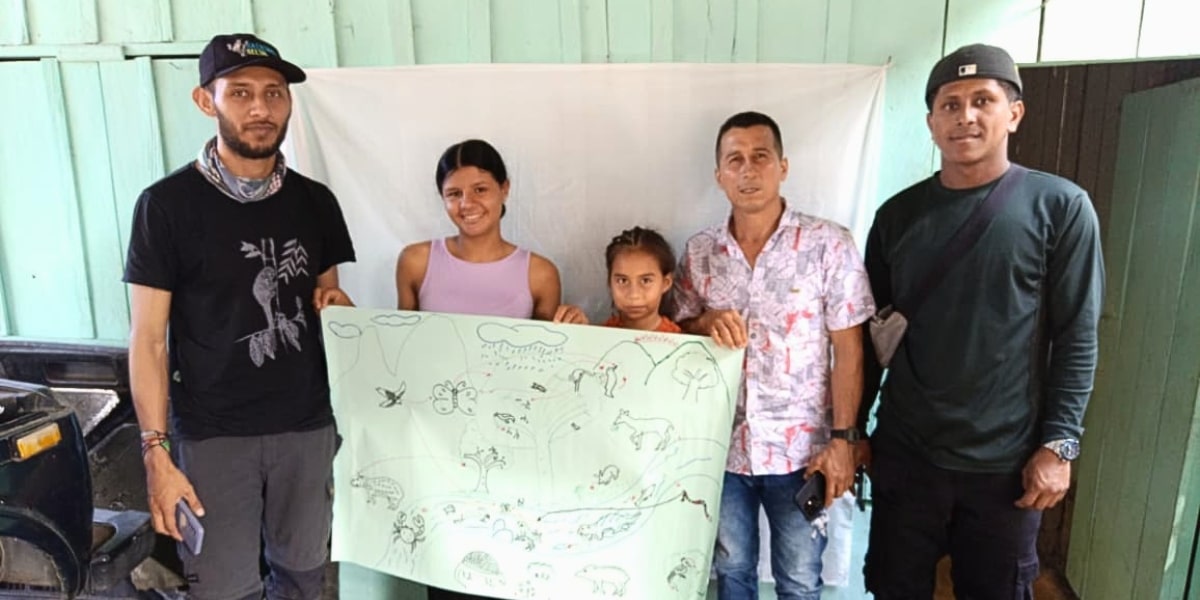 The four ambassadors, both men and women, with a map of the region